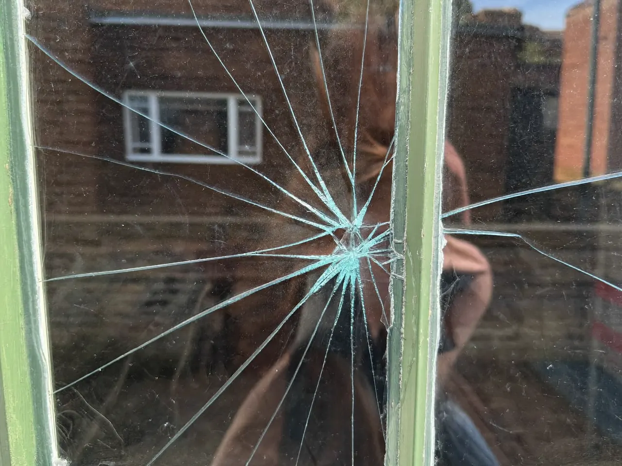 A crack running across a double-glazed window pane in a home