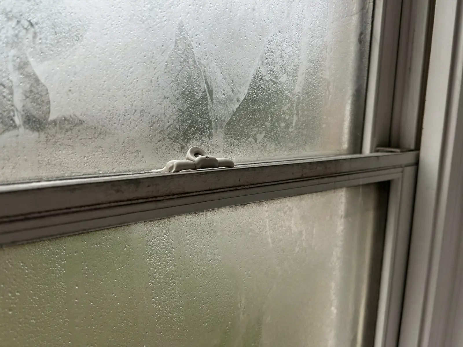 Close-up of a misted double glazing unit with condensation between the panes