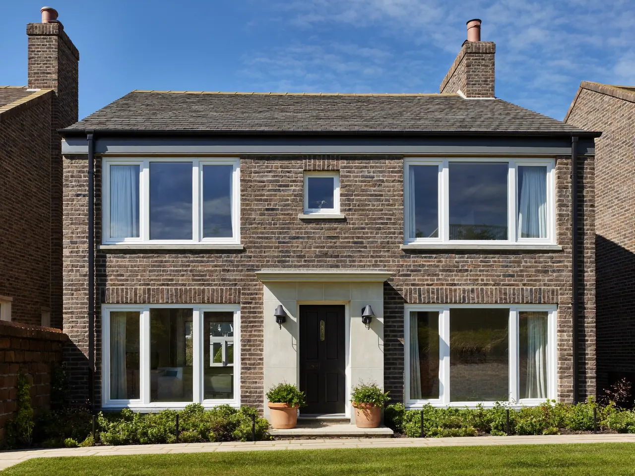 Newly fitted double-glazed windows on the front of a UK home